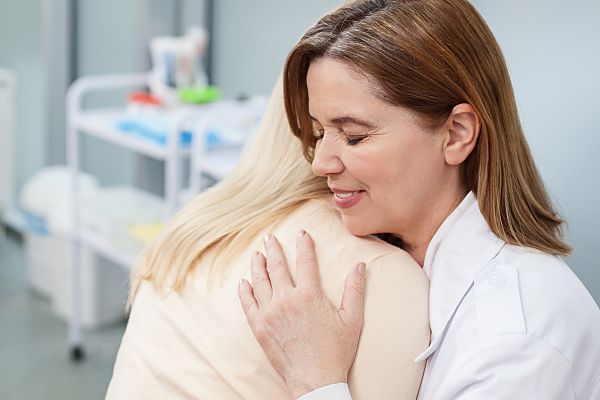 doctor hugging young patient in emergency room